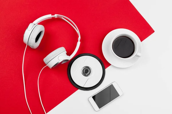 Headphones with cord on red and white color background — Stock Photo, Image