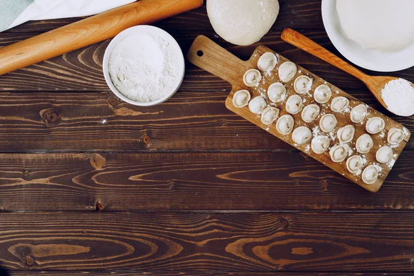 Gnocchi russi ripieni crudi su tavola di legno — Foto Stock