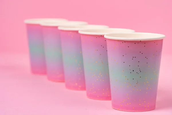 Pink disposable paper cups on pink background — Stock Photo, Image