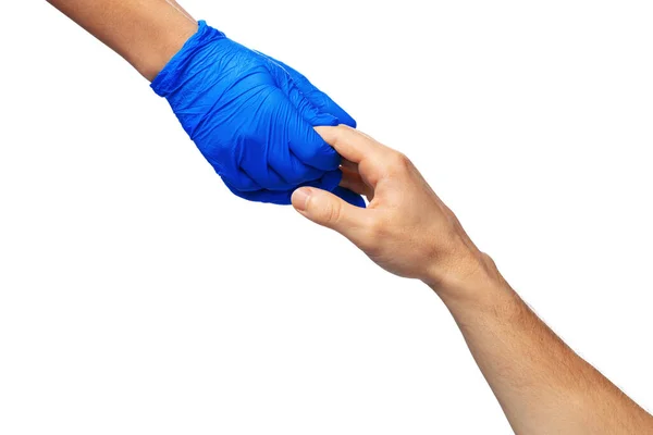 Male and female hands in medical gloves stretch to each other. Help concept. — Stock Photo, Image