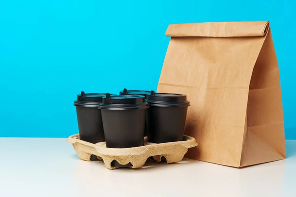 Xícaras de café e pacote de comida takeaway. Refeição de retirada — Fotografia de Stock