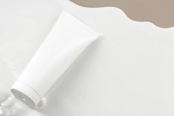 Üres fehér bőrápoló termék cső bézs alapon — Stock Fotó