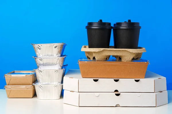 Assortment of various food delivery containers on table — Stock Photo, Image