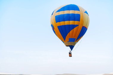 Açık mavi gökyüzünde çok renkli hava balonu