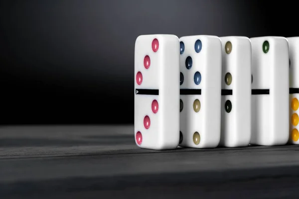 Domino game. Dominoes on a black table