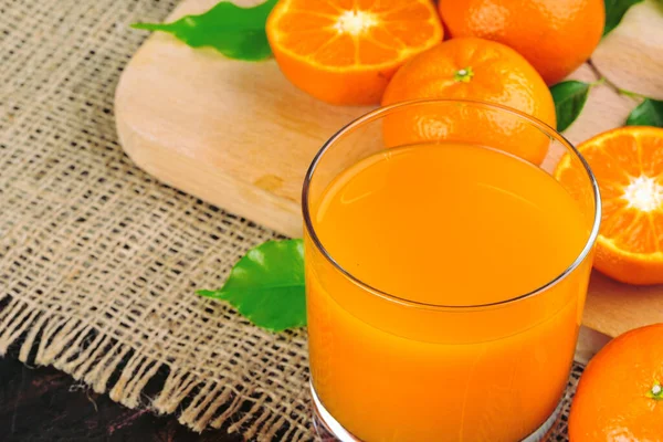 Glass of orange juice and orange slices — Stock Photo, Image
