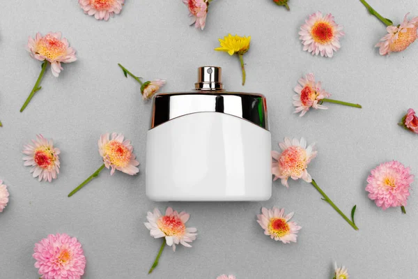 Bottle of fragrance surrounded by flower buds — Stock Photo, Image