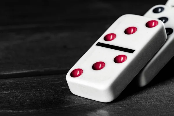 Domino game. Dominoes on a black table