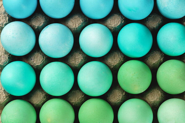 Traditional Christian eastertime, painted eggs in egg box.