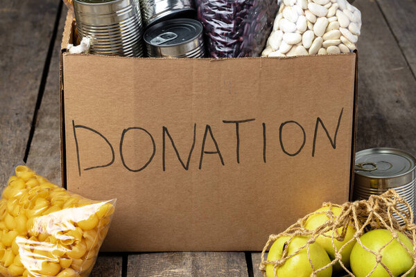 Food donations on the table. Text Donation.