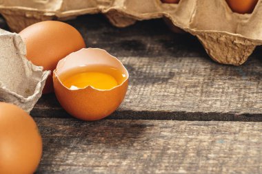 Yumurtanın yarısı ahşap masada kırıktır.