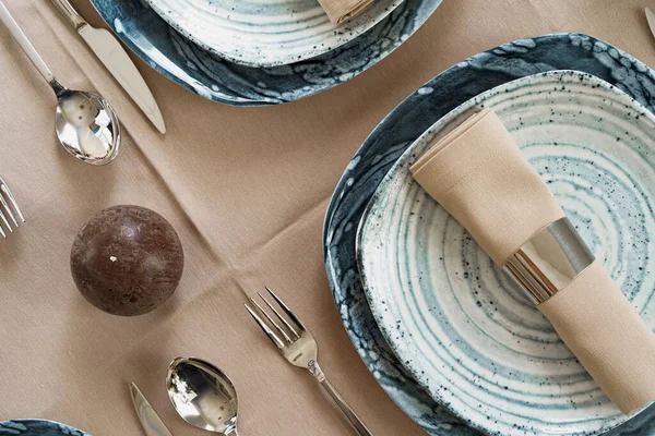 Details of a stylish table setting with textured ceramic dishes — Stock Photo, Image