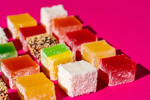 Turkish delight square pieces on a bright pink background — Stock Photo, Image