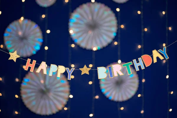 Happy birthday garland and decorations on blue background — Stock Photo, Image