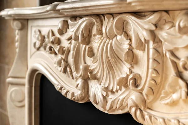 Carved patterns on stone luxury fireplace close up