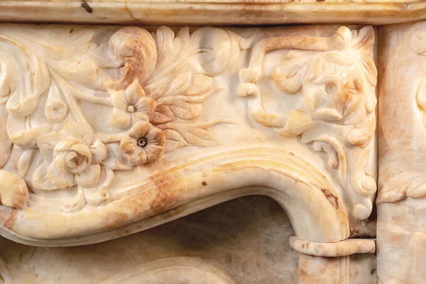 Carved patterns on stone luxury fireplace close up — Stock Photo, Image