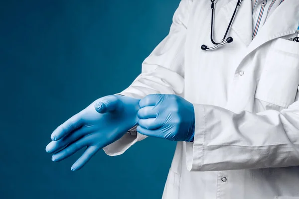 Доктор носить блакитні медичні рукавички на руках . — стокове фото