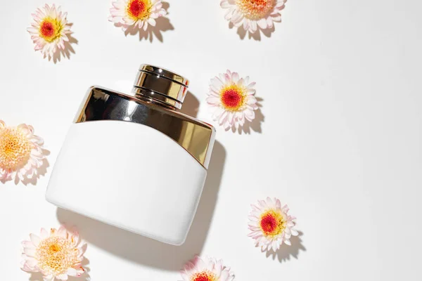 Bottle of fragrance surrounded by flower buds — Stock Photo, Image