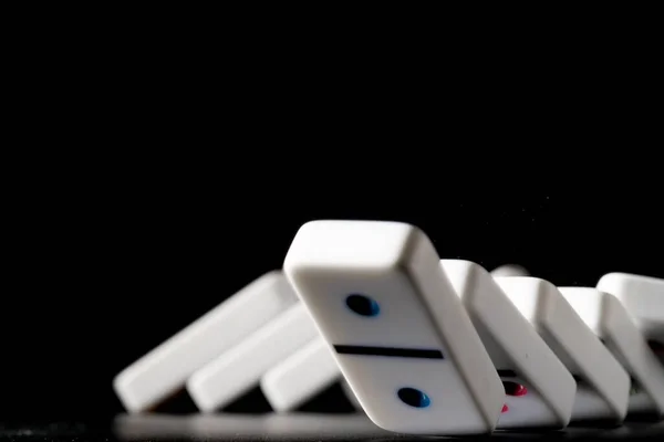 Dominoes standing in a row on black background — Stock Photo, Image