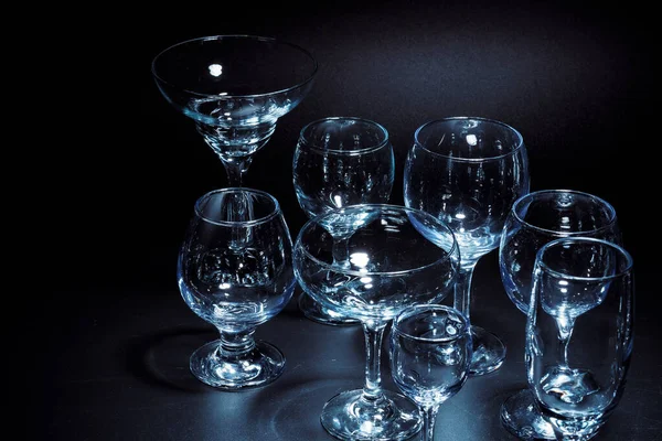 Empty glasses for drinks on dark background — Stock Photo, Image