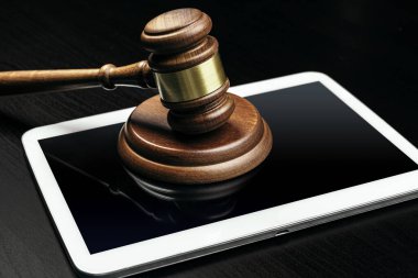 Siber suç konsepti. Yargıç Tokmak ve tablet bilgisayar masada.