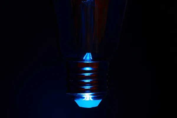 Light bulb on black background close up — Stock Photo, Image