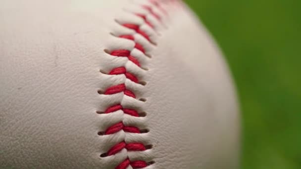 Close up of baseball ball on green background — Stock Video