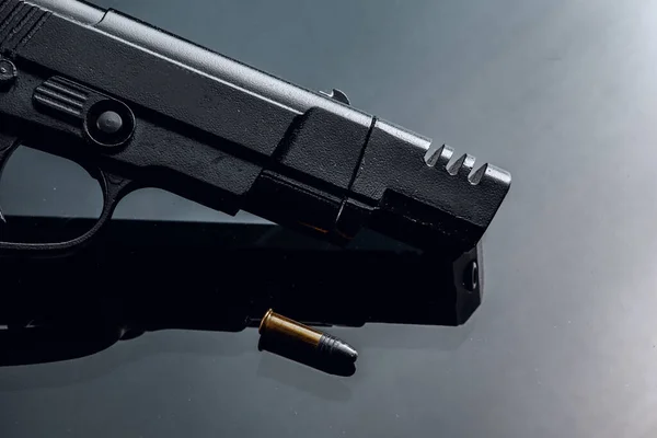 Black handgun on black background with reflection — Stock Photo, Image