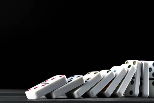 Domino game. Dominoes on a black table