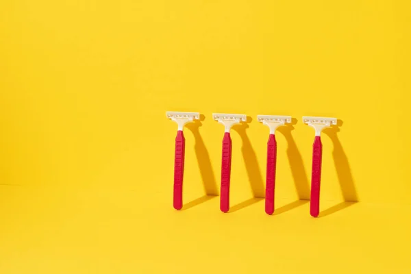 Studio shot of disposable razor tools on yellow