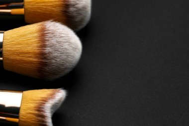 Siyah arkaplanda makyaj fırçası koleksiyonu