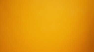 Eldivenler içinde insan eli sarı arka planda diğerine bağış kutusunu uzatırken, Coronavirus bağışları yardımcı oluyor.