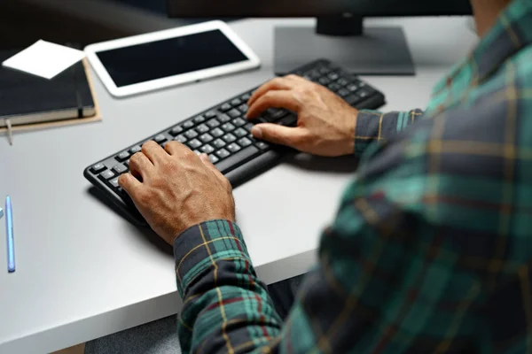 Black man hands typing on computer keyboard