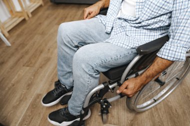 Tekerlekli sandalyede oturan tanınmayan engelli adam.