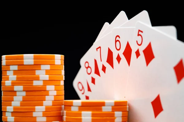 Playing cards and chips on green casino table background