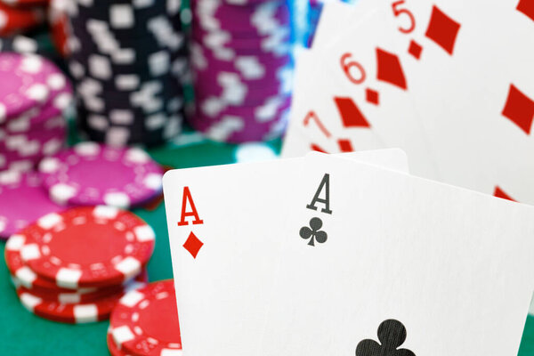 Playing cards and chips on green casino table background
