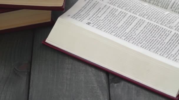 Open book on gray wooden table close up — Stock Video