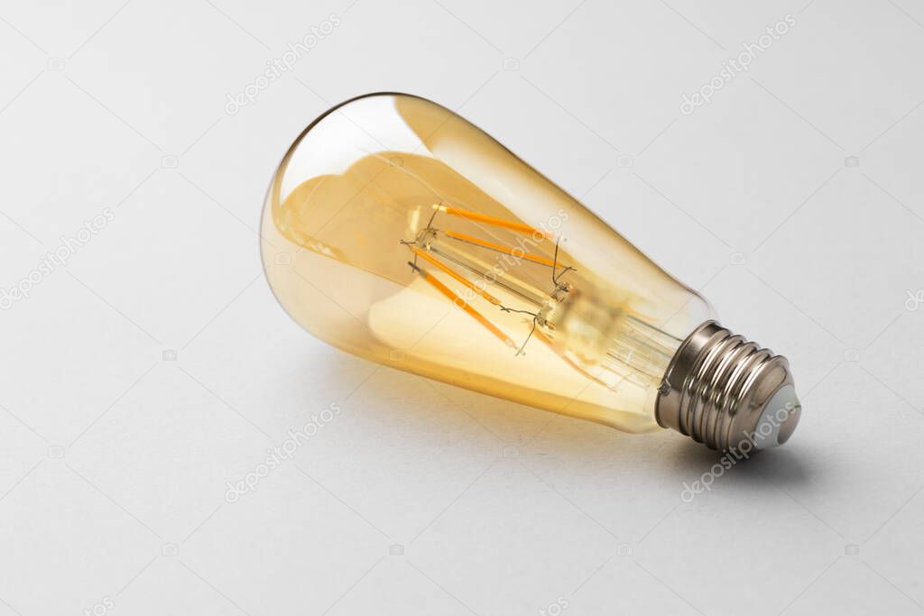 Light bulb on light grey paper background
