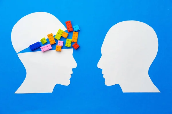 Papercut silhouette of human head with colorful constructor pieces — Stock Photo, Image
