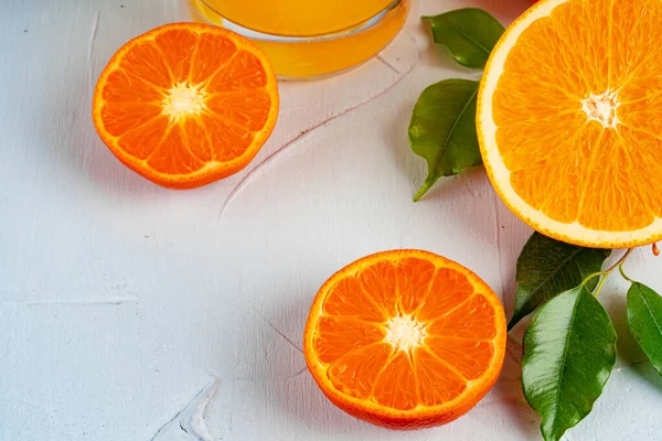 Half cut orange with green leaf on table — Stock Photo, Image