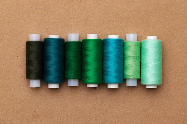 Many colored spools of threads as a background