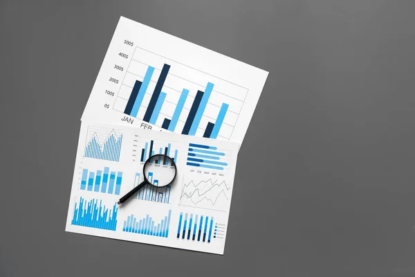 Papel financiero con gráficos y diagramas sobre mesa gris —  Fotos de Stock