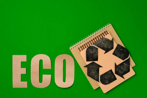Paper recycling concept on green background top view