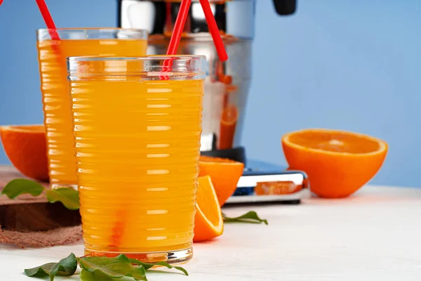 Glass of orange juice with red straw on table — Stock Photo, Image