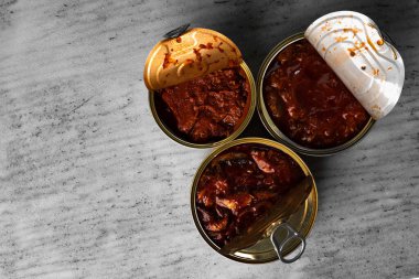 Gri ahşap masada konserve balık konserveleri