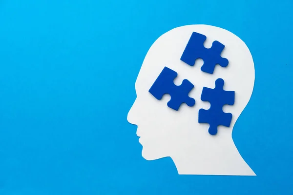 Papercut huvud med pussel bitar på blå bakgrund — Stockfoto