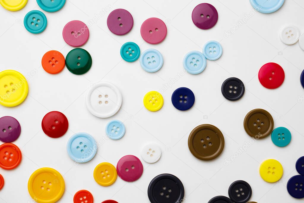 Assortment of colorful buttons on white background