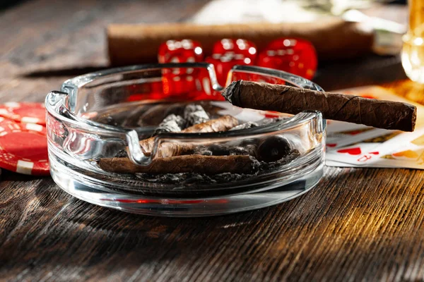 Close up of cigar and red dice cubes, gambling concept