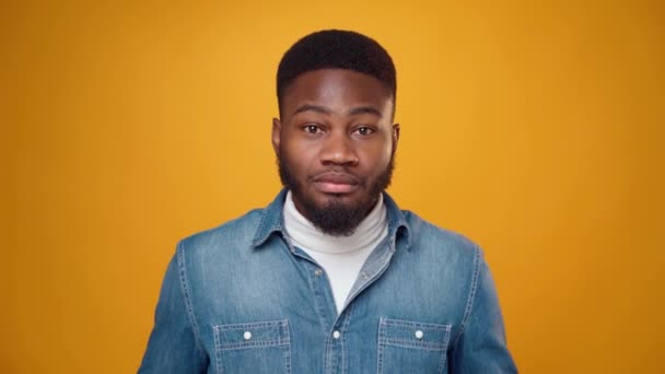 Африканский американец, показывающий свой ум, взорван на жёлтом фоне — стоковое видео