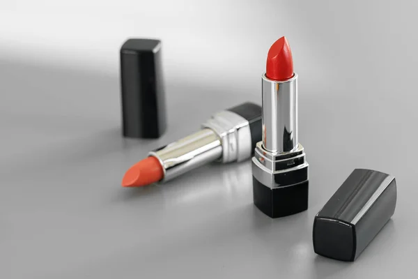 Pink and red lipsticks on vanity table — Stock Photo, Image